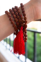  Japamala on the hand. Prayer beads. Religious equipment