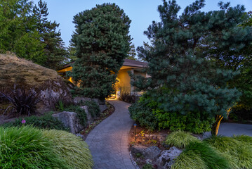Entrance of luxury house with nice spring blossom landscape at night in Vancouver, Canada, North...