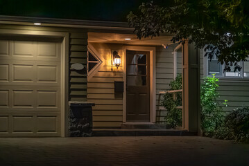 Entrance of luxury house with nice spring blossom landscape at night in Vancouver, Canada, North...