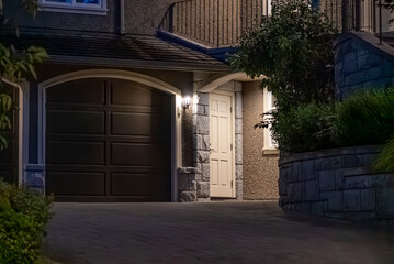 Entrance of luxury house with nice spring blossom landscape at night in Vancouver, Canada, North...