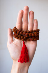  Japamala on the hand. Prayer beads. Religious equipment