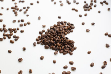 Coffee beans after roasting against a pure white background. Coffee.