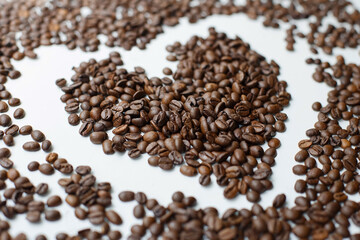 Coffee beans after roasting against a pure white background. Coffee.