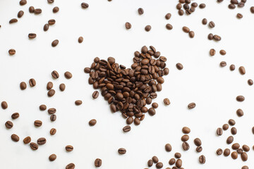 Coffee beans after roasting against a pure white background. Coffee.
