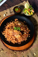 Aromatic Chicken Mandi Rice with Spiced Grilled Chicken and Yellow Rice Garnished with Fried Onions and Salad