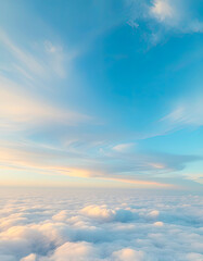 Fototapeta premium Soft pastel sky above fluffy clouds at sunrise, serene and peaceful aerial view with light blue and warm tones, atmospheric nature background for relaxation and inspiration