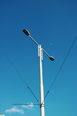 electricity pylon against blue sky