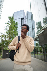 Young businessman is thinking about his next move while walking in the city