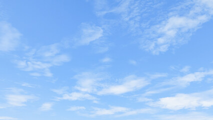 Clear blue sky with soft cloud with daylight natural background. Soft white clouds float in the clear blue sky. Clear blue sky, bright spring, soft sky gradient.