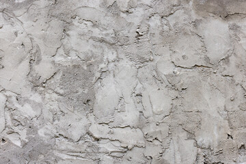 Grey dry concrete outdoor wall during daytime with rough surface - texture and background