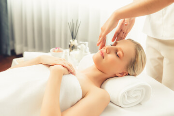 Caucasian woman enjoying relaxing anti-stress head massage and pampering facial beauty skin...