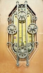 Antique door, wrought iron lattice window insert detail.