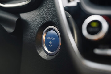 Modern car engine start button. Power push button on dashboard. Closeup of ignition control in...