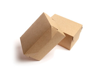 Two brown cardboard boxes are positioned at an angle, showcasing their unique folding design and...
