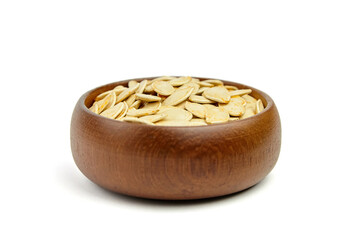 Wooden bowl filled with raw pumpkin seeds, showcasing their natural texture and color, perfect for healthy snacking or culinary use in various dishes and recipes