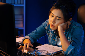 Exhausted young beautiful Asian creative feeling sleepy, looking on pc to wait email sending back...