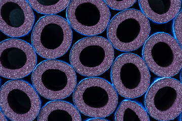 A pile of foam pipe insulation foam tubes used for insulating water pipes to prevent heat loss and...