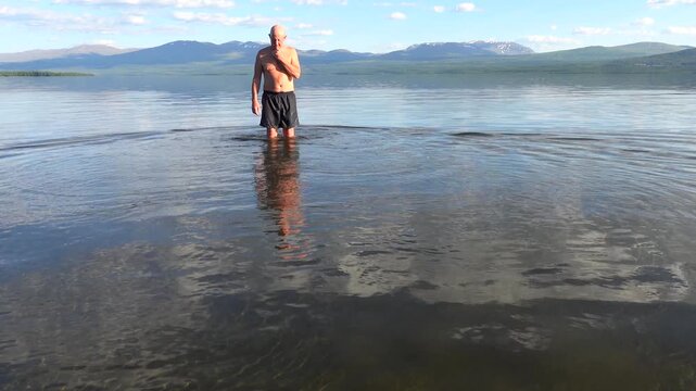 Klocka, Sweden A man bathes in the remote &Aring;nnsj&ouml;n Lake in the J&auml;mtland region.  