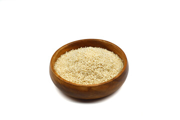 Top view closeup of freshly harvested white sesame in wooden bowl isolated on white background with clipping path.