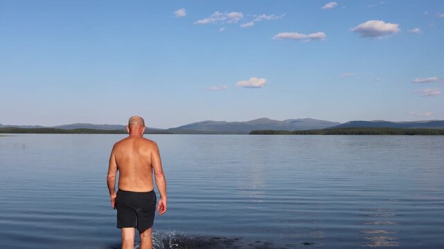 Klocka, Sweden A man bathes in the remote &Aring;nnsj&ouml;n Lake in the J&auml;mtland region.  