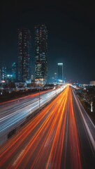 Fototapeta premium Highway in the city, night view, long exposure light trails and skyscrapers
