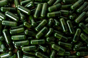 Green powder in pill form 