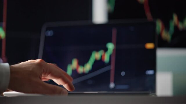 Laptop monitors data charts in broker office closeup. Investor studying graphs