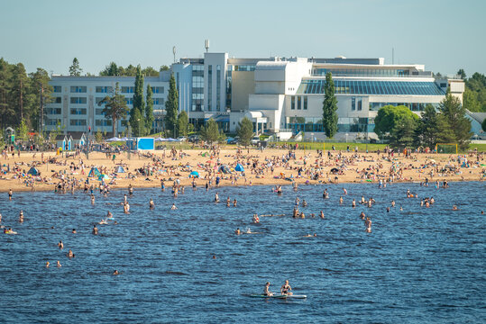 Finland. Sandy beach of Oulu city. Many people relax on a hot summer day on the sea beach.