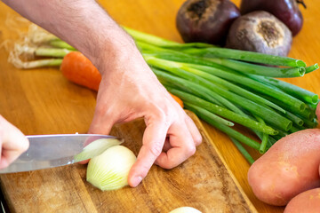Chopping Green Onions on Rustic Wooden Cutting Board