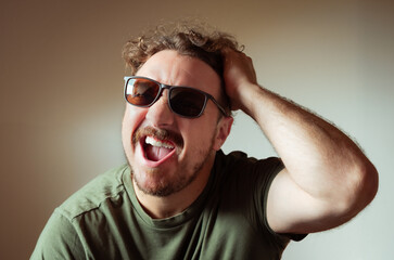 Obraz premium Man with Sunglasses Yelling or Reacting Strongly