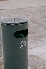 trash can marked Do not litter. green round container for waste collection. garbage sorting,...