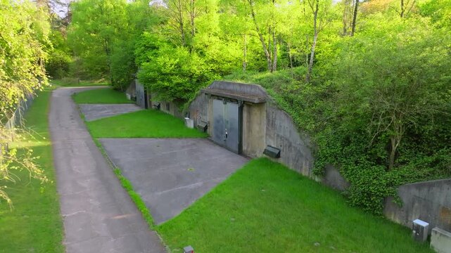 Hidden ammunition bunker located in a forested area amid rising global tensions and potential conflicts