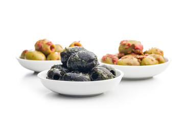 Tapas. Flavored pickled olives in bowl isolated on white background.