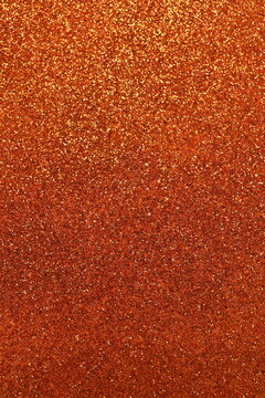 Blurred shiny orange glitter texture background
