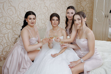 Bridal party celebrating with champagne in elegant setting before wedding ceremony