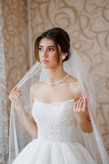 Elegant bride preparing for her wedding day in a decorated indoor setting