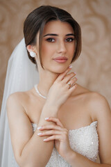 Elegant bridal portrait featuring a young woman with a sophisticated hairstyle and makeup