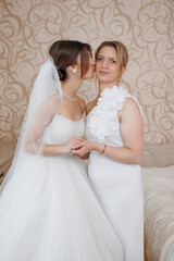 Bride shares a tender moment with her mother before the wedding ceremony in a beautiful setting