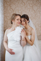 Bride and mother share intimate moment in elegant room before wedding ceremony