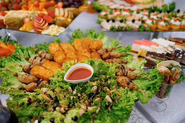 Colorful platter of assorted appetizers at a festive gathering in a banquet hall