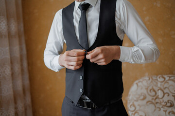 Groom preparing for wedding in elegant suit before ceremony