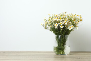 Beautiful bouquet of daisies in a vase on the table