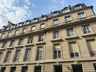 Obraz premium Facade of high building with brick walls and big windows