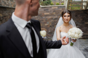 Couple shares an emotional moment in a wedding setting despite being slightly out of focus