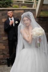 Bride and groom capture a romantic moment outdoors with elegance and beauty