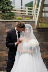 Romantic wedding moment captured outdoors with bride and groom at a beautiful venue