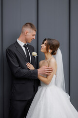 Elegant couple shares a romantic moment during a wedding ceremony in a stylish venue