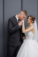Couple shares a romantic moment during wedding ceremony near modern architecture