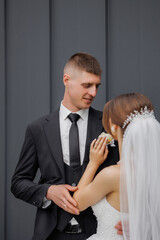 Couple shares a tender moment before their wedding ceremony in a stylish outdoor setting