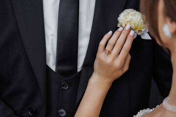 Couple shares a tender moment during a wedding ceremony in a garden setting